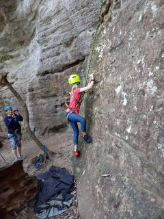 Adventurous girl rock climbing at the Grotto.